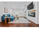 Relaxing living area with a fireplace, mounted TV, elegant decor, and comfortable seating arrangement at 958 Crew Sw St, Atlanta, GA 30315