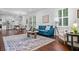 Open-concept living space featuring hardwood floors, neutral tones, and ample natural light from shuttered windows at 958 Crew Sw St, Atlanta, GA 30315