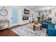 View of the living room showing a fireplace, mounted TV, access to kitchen, and stylish decor at 958 Crew Sw St, Atlanta, GA 30315