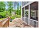 Relaxing screened-in patio and landscaped backyard with a stone walkway at 11190 Serenbe Ln, Chattahoochee Hills, GA 30268