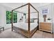 Bright bedroom with a four-poster bed, rug, and natural light from nearby windows at 11190 Serenbe Ln, Chattahoochee Hills, GA 30268
