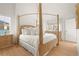 Elegant bedroom with a four-poster bed, hardwood floors, and ample natural light at 11190 Serenbe Ln, Chattahoochee Hills, GA 30268