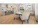 Open-concept dining area with a round table, chairs, and adjacent kitchen for easy entertaining at 11190 Serenbe Ln, Chattahoochee Hills, GA 30268