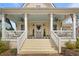 Charming home with a welcoming porch, white railings, and light stone steps leading to the entrance at 11190 Serenbe Ln, Chattahoochee Hills, GA 30268