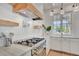 Close up of chef's kitchen with stainless steel range and designer tile backsplash at 11190 Serenbe Ln, Chattahoochee Hills, GA 30268