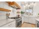 Bright kitchen featuring stainless steel appliances, subway tile backsplash, and a view from the window at 11190 Serenbe Ln, Chattahoochee Hills, GA 30268