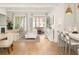 Bright, open-concept living room with hardwood floors and French doors leading to outdoor space at 11190 Serenbe Ln, Chattahoochee Hills, GA 30268