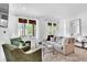 Bright living room featuring hardwood floors, comfortable seating, and plenty of natural light at 11190 Serenbe Ln, Chattahoochee Hills, GA 30268