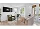 Well-lit living room featuring french doors, a large sofa, and two accent chairs at 11190 Serenbe Ln, Chattahoochee Hills, GA 30268