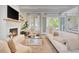 Bright living room featuring a cozy fireplace and French doors to the outside at 11190 Serenbe Ln, Chattahoochee Hills, GA 30268