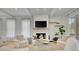 Bright living room featuring a cozy fireplace, beamed ceilings, and stylish decor for a comfortable atmosphere at 11190 Serenbe Ln, Chattahoochee Hills, GA 30268