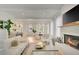 Open-concept living space with modern kitchen, dining area, comfortable seating and fireplace at 11190 Serenbe Ln, Chattahoochee Hills, GA 30268