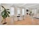 Open-concept living and dining area with hardwood floors and elegant lighting fixture at 11190 Serenbe Ln, Chattahoochee Hills, GA 30268