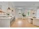 Open-concept living space features a modern kitchen and dining area with ample natural light at 11190 Serenbe Ln, Chattahoochee Hills, GA 30268