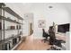 Office space with built-in shelving, vaulted ceilings, and hardwood floors at 11190 Serenbe Ln, Chattahoochee Hills, GA 30268