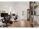 Home office with vaulted ceilings, two desks and chairs and hardwood floors at 11190 Serenbe Ln, Chattahoochee Hills, GA 30268