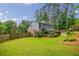 A well-manicured backyard with an outbuilding, mature trees, and landscaping at 3389 Robinson Farms Ne Trce, Marietta, GA 30068