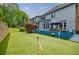 Relax in this home's backyard, with an artificial putting green and lush landscaping at 3389 Robinson Farms Ne Trce, Marietta, GA 30068