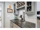 Granite countertop wet bar area features a wine rack and glass storage above at 3389 Robinson Farms Ne Trce, Marietta, GA 30068