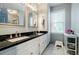Bright bathroom featuring double sinks, elegant mirrors, white cabinetry, and natural light at 3389 Robinson Farms Ne Trce, Marietta, GA 30068