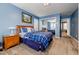 Cozy bedroom with blue walls, wood furniture, and a mirror closet offering space for relaxation at 3389 Robinson Farms Ne Trce, Marietta, GA 30068