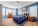 Bedroom features a bed with blue covers, blue walls, carpeted floors, and two windows at 3389 Robinson Farms Ne Trce, Marietta, GA 30068