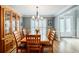 Elegant dining room with hardwood floors, a large wooden table with seating for six, and a display cabinet at 3389 Robinson Farms Ne Trce, Marietta, GA 30068