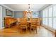 Dining room with hardwood floors, a wooden table with seating, and large windows with plantation shutters at 3389 Robinson Farms Ne Trce, Marietta, GA 30068