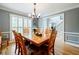 Dining room with hardwood floors, a wooden table with seating, and view towards the entrance foyer and staircase at 3389 Robinson Farms Ne Trce, Marietta, GA 30068