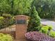 Robinson Farms entrance sign surrounded by brickwork, shrubs, and trees adds charm and defines the welcoming community at 3389 Robinson Farms Ne Trce, Marietta, GA 30068
