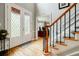 Bright foyer featuring hardwood floors, a staircase with iron spindles, and a glass-paneled front door at 3389 Robinson Farms Ne Trce, Marietta, GA 30068