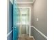 Hallway featuring light blue door, neutral walls, and view to a staircase at 3389 Robinson Farms Ne Trce, Marietta, GA 30068