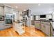 Spacious kitchen with granite countertops, a center island, stainless steel appliances, and hardwood floors at 3389 Robinson Farms Ne Trce, Marietta, GA 30068