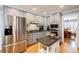 Well-lit kitchen with stainless steel appliances, gray cabinets, granite counters, and hardwood flooring at 3389 Robinson Farms Ne Trce, Marietta, GA 30068