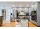 Well-lit kitchen features granite countertops, stainless appliances, and light gray cabinetry at 3389 Robinson Farms Ne Trce, Marietta, GA 30068