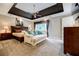 Spacious bedroom featuring tray ceilings, a sitting area, and neutral decor at 3389 Robinson Farms Ne Trce, Marietta, GA 30068