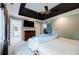 A bright main bedroom with a ceiling fan, a TV, a couch, and an entry to the main bathroom at 3389 Robinson Farms Ne Trce, Marietta, GA 30068
