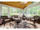 Relaxing sunroom with wicker furniture, tile flooring, and scenic views at 3389 Robinson Farms Ne Trce, Marietta, GA 30068
