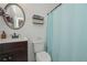 Cozy bathroom featuring a stylish vanity and a round mirror above the toilet at 510 Boulder View Parkway, Dallas, GA 30157