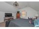Attic bedroom with a ceiling fan, television, and closet, offering comfort and functionality at 510 Boulder View Parkway, Dallas, GA 30157