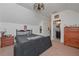 Large attic bedroom with ceiling fan, a bedroom set, and bathroom access at 510 Boulder View Parkway, Dallas, GA 30157