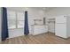 Well-lit mini kitchen with white cabinets, wood counters, new appliances, and wood grain floors at 510 Boulder View Parkway, Dallas, GA 30157