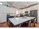 Bright kitchen boasts white cabinets, dark blue island, and modern appliances, perfect for cooking and entertaining at 510 Boulder View Parkway, Dallas, GA 30157