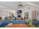 Cozy living room with a brick fireplace, ceiling fan, and comfortable blue sectional sofa at 510 Boulder View Parkway, Dallas, GA 30157
