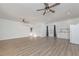 Spacious living room with wood floors, white walls, ceiling fans, and a mini kitchen area at 510 Boulder View Parkway, Dallas, GA 30157