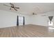 Open living room with wood floors, ceiling fans, and a glass door for natural lighting at 510 Boulder View Parkway, Dallas, GA 30157