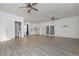 Wide view of spacious living area with wood flooring, ceiling fans, and a mini kitchen to the side at 510 Boulder View Parkway, Dallas, GA 30157
