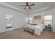 Bright main bedroom with a sitting area and an adjacent bathroom with shower at 510 Boulder View Parkway, Dallas, GA 30157