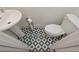Cozy powder room featuring bold tile flooring, a pedestal sink, and a toilet at 510 Boulder View Parkway, Dallas, GA 30157