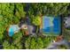 Aerial view showcases a swimming pool and tennis courts surrounded by lush greenery at 602 Country Park Se Dr, Smyrna, GA 30080